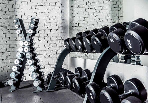 Well-ordered weight training equipment in modern sports club