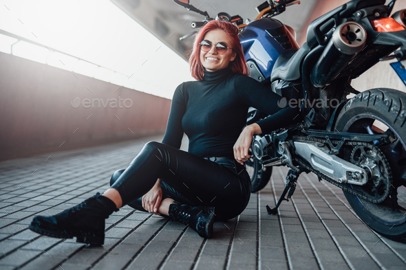 Young female biker posing near motor bike woman Vector Image