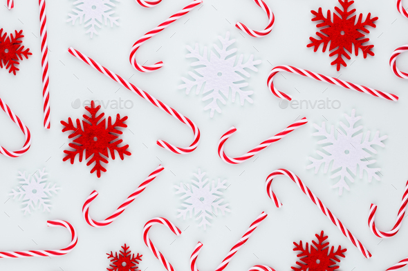 Christmas candy cane lied on blue background. Flat lay and top view.