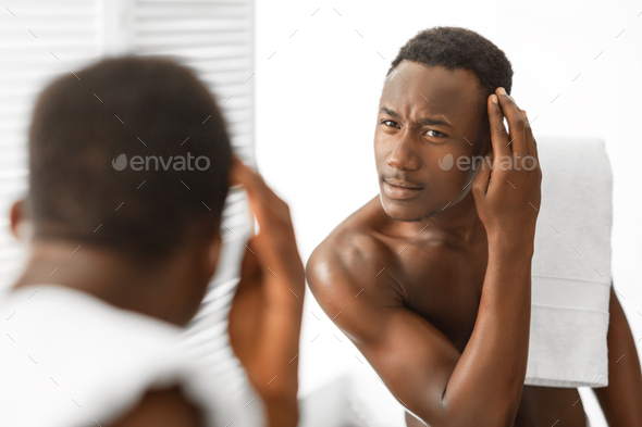 Black Man Examining Hair On Head Having Dandruff In Bathroom