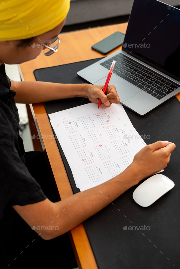 Woman marking 2021 US holidays on a calendar