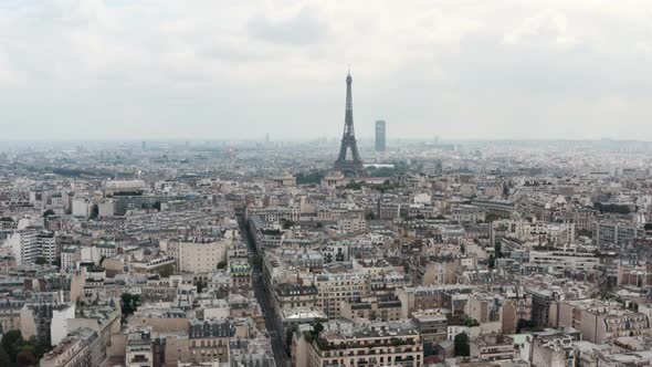 Slider drone shot of the Eiffel Tower with classic Paris style buildings in the foreground alt