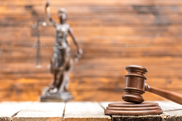Close-up view of brown wooden mallet of judge on wooden table, law concept