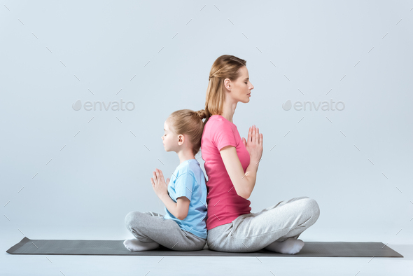 Caucasian Mother Daughter Doing Yoga Poses Carpet Stock Photo by  ©DragonImages 216524150