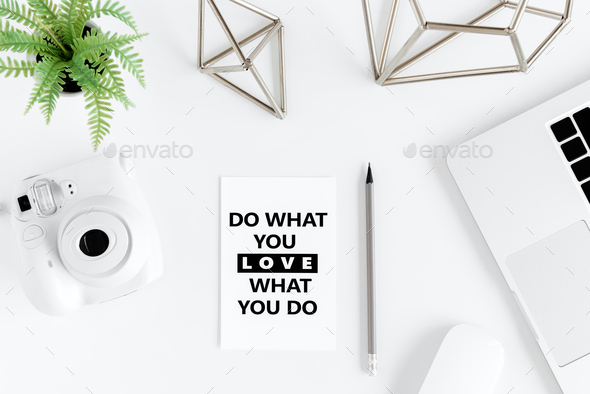 Top view of do what you love, love what you do motivational quote and laptop at workplace