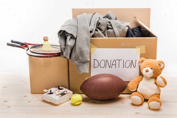 cardboard boxes with donation clothes and different objects isolated on white, donation concept
