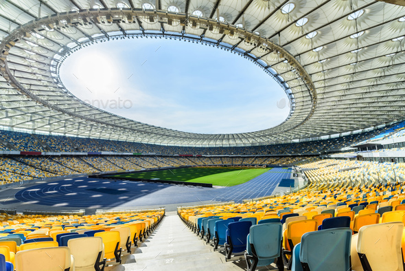 Rows Of Yellow And Blue Stadium Seats On Soccer Field Stadium Stock Photo By Lightfieldstudios