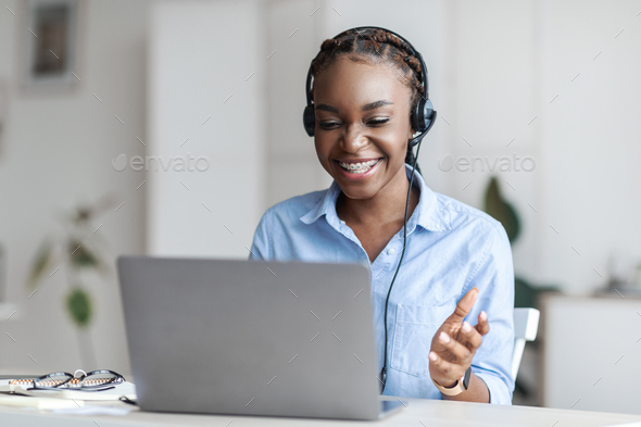 Online Tutoring. Black Female Tutor In Headset Having Video Conference With Laptop