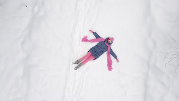 Traveler Woman in Pink Clothes a Scarf and a Hat and Sunglasses is Lying alt