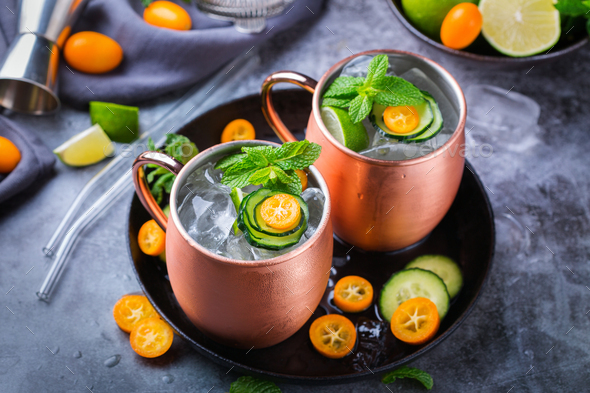 Moscow mule cocktail with lime, mint, cucumber and kumquat - Stock Photo - Images