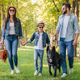 young happy interracial family with picnic basket walking with dog in forest - PhotoDune Item for Sale
