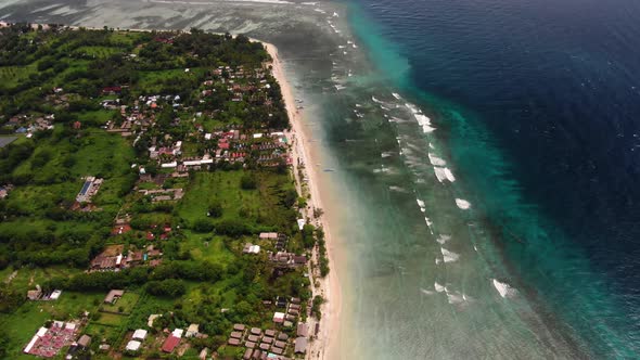 Aerial view of a beautiful coastline with the incoming waves alt