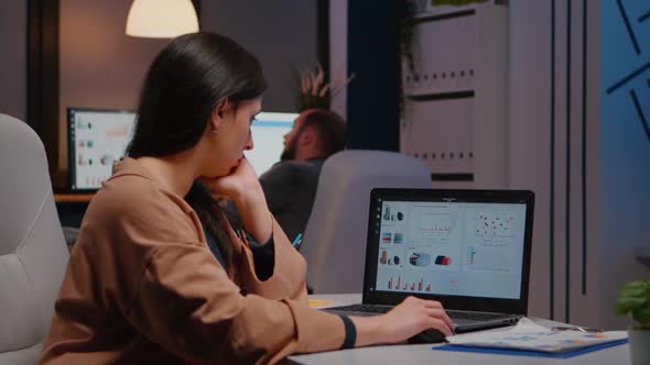 Tired Workaholic Executive Businesswoman Typing Financial Strategy on Laptop Computer alt