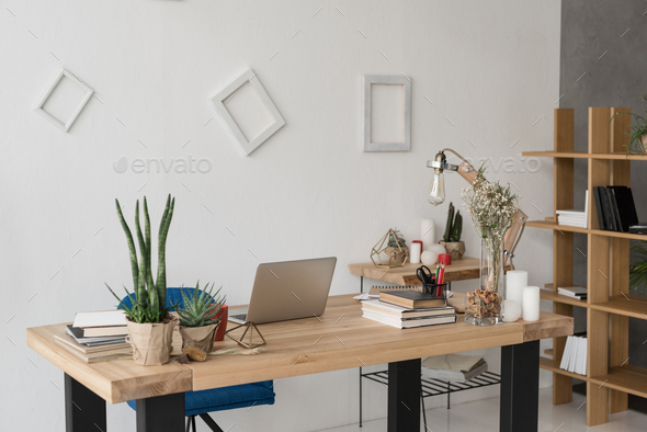 office table with laptop, books, candles and office supplies Stock ...