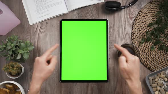 Top View. Big Tab on the Table with Chromakey Screen on It. Hands Show Thumbs Up alt