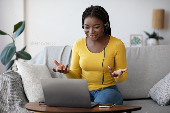 Online Tutoring Concept. Friendly African Lady Tutor Having Video Call On Laptop