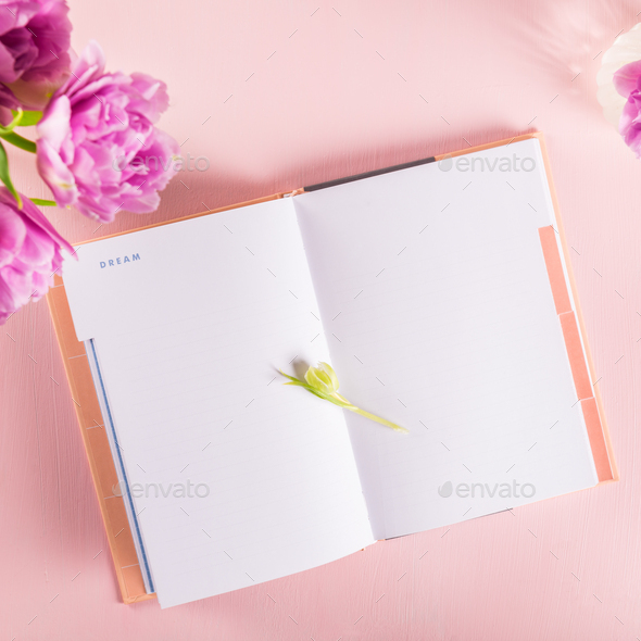 Open Notebook for writing Dreams and Ideas with flowers nearby Stock