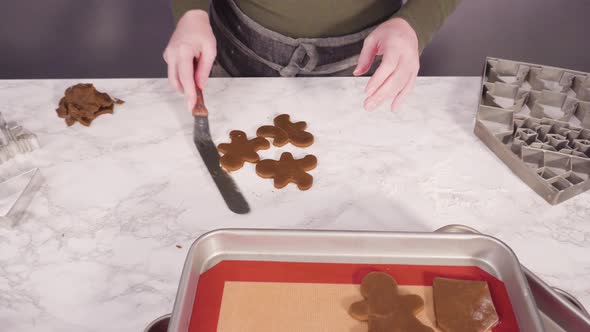 Step by step. Cutting out shapes with Christmas cookies cutter from gingerbread cookie dough. alt