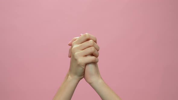 Close up of hand clapping on the pink background. celebration concept. alt