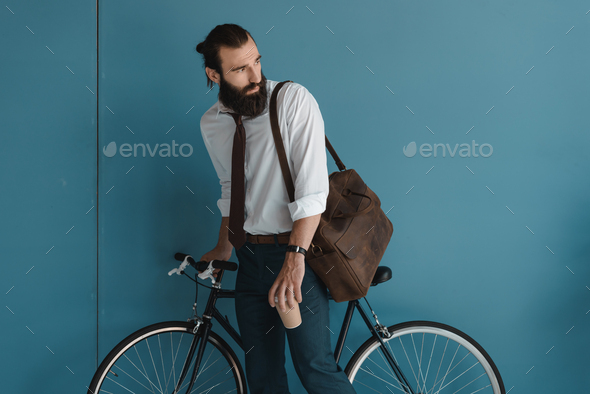 young businessman with vintage bicycle and coffee to go