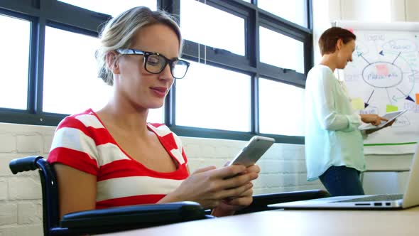 Female executive using mobile phone alt