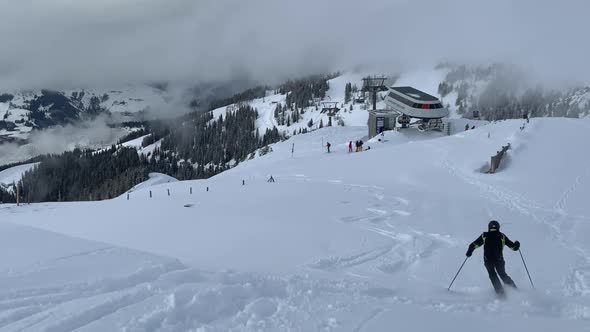 A Skier Skiing On The Downhill And Leaving A Track On The White Snow - Ski Resort In Austria During alt