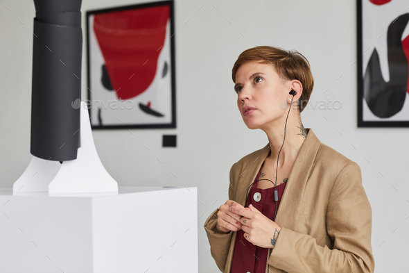 Young Woman Looking at Modern Art in Museum