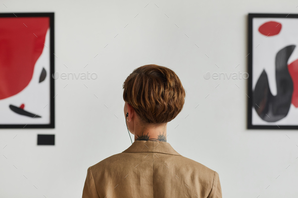 Young Woman Looking at Modern Art Back View
