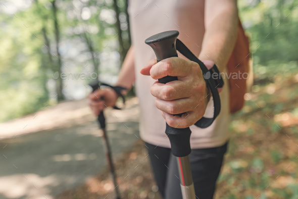 Female hiker hand holding trekking pole