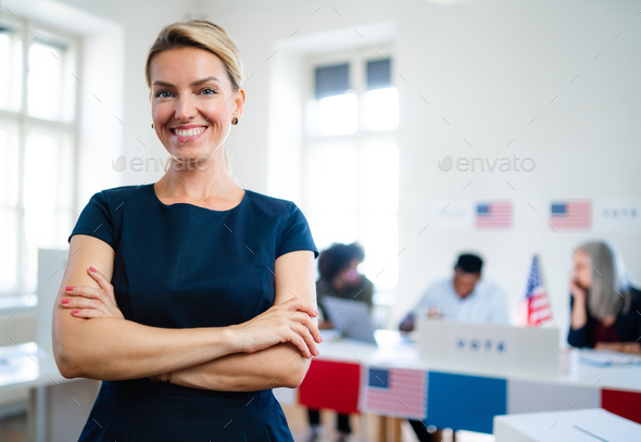 Portrait of confident woman voter in polling place, usa elections concept
