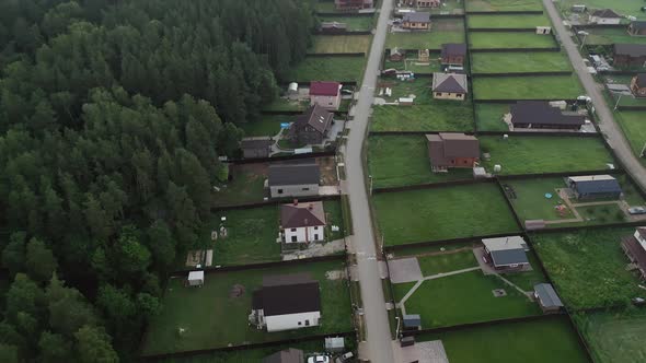 A View From Above at the Cottage Village Areas and Infrastructure Roads Houses Dense Forest and the alt