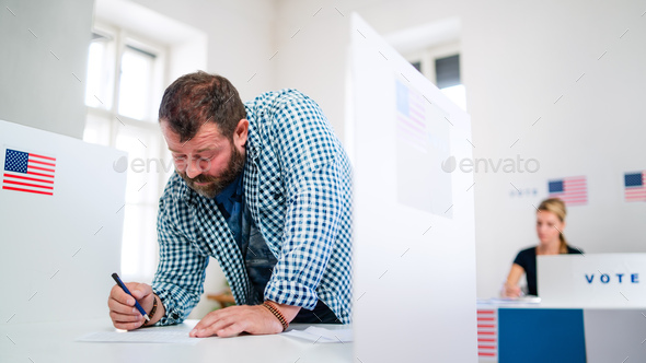 Portrait of man voter in polling place, usa elections concept