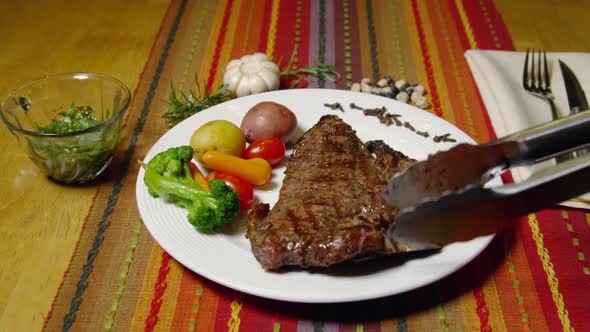 A Porterhouse Or T-bone Steak Served With Vegetables 46
