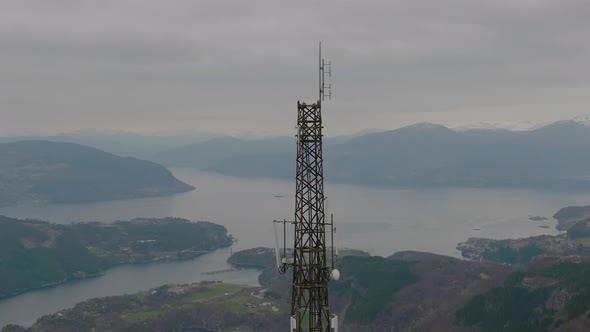 Aerial orbit around cell tower on top of mountain, panoramic view alt