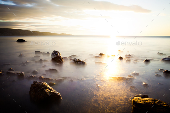 Stones in ocean, shrouded in fog - Stock Photo - Images