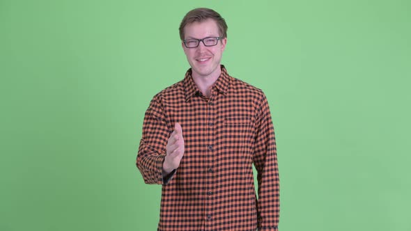 Happy Young Hipster Man Giving Handshake alt