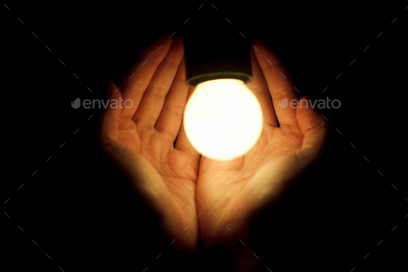 hands of human holding illuminated led bulb on black background Stock Photo  by Sonyachny