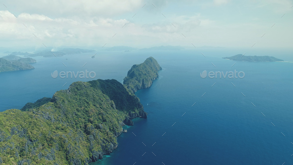 Tropical highland island aerial view at blue ocean bay. Asia mountainous isle with exotic nature