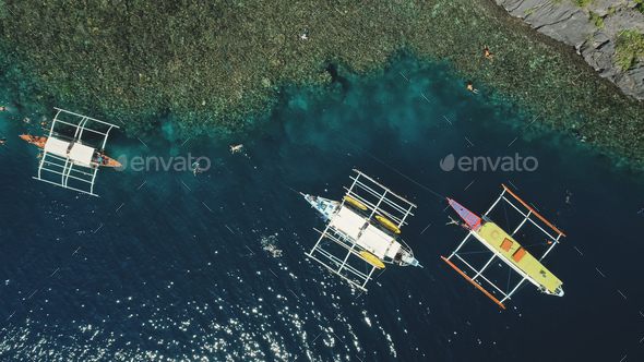 Top down of boats at green mount ocean coast aerial view. Epic summer landscape with vessels - Stock Photo - Images