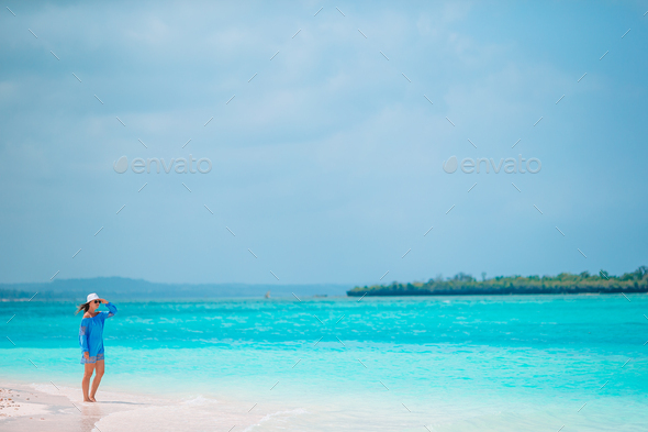 Young beautiful woman having fun on tropical seashore. Happy girl background the blue sky and - Stock Photo - Images