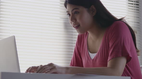 Asian woman successful happy cheerful smiling using a laptop.