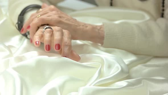 Senior Woman Manicured Hands with Jewelry. alt