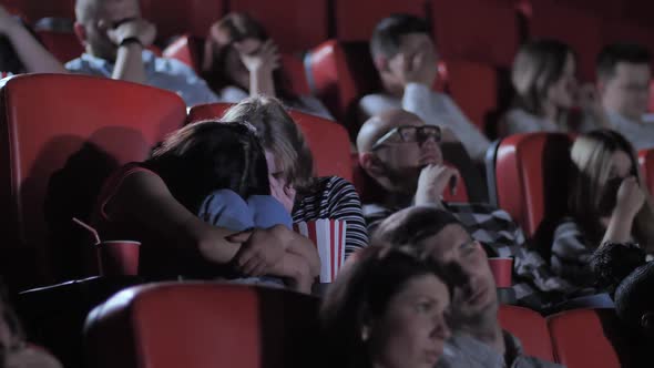 Two Schoolgirls Watching Exciting Horror in Cinema alt
