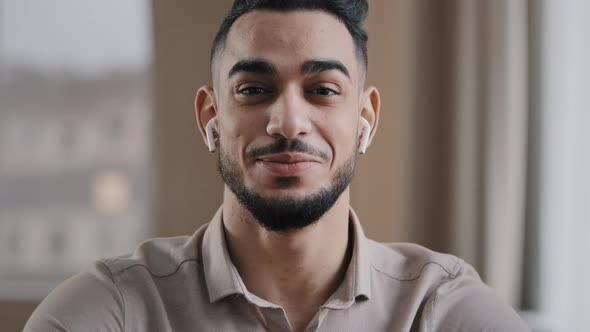 Happy Young Coach Arab Man Blogger Wears Wireless Earphones Say Hello at Camera Subscribers Record alt