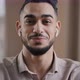 Happy Young Coach Arab Man Blogger Wears Wireless Earphones Say Hello at Camera Subscribers Record - VideoHive Item for Sale
