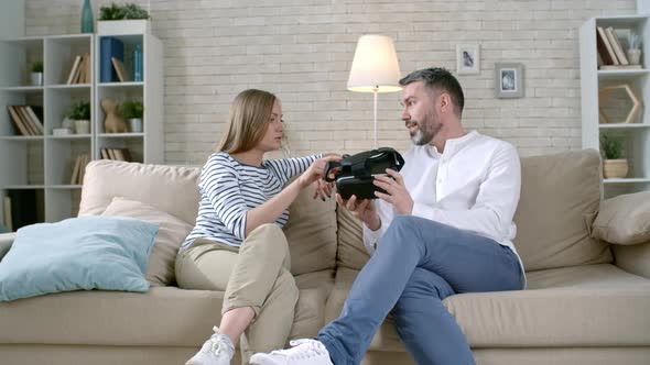 Woman and Man Discussing VR Headset alt