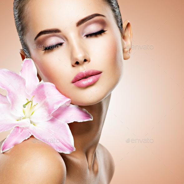 Beauty pure face of the young beautiful girl with flower - Stock Photo - Images