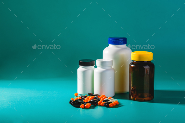 Bottle and Pills On green Background. Medicine Healthcare Pharmacy Concept.  Coronavirus. Stock Photo by Irrin