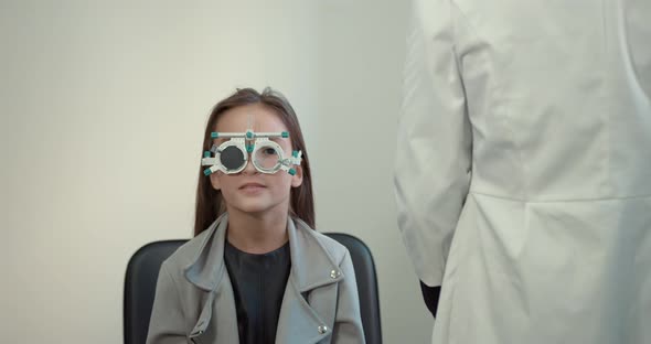 Schoolgirl Girl in a Bright Modern Optometrist's Office alt