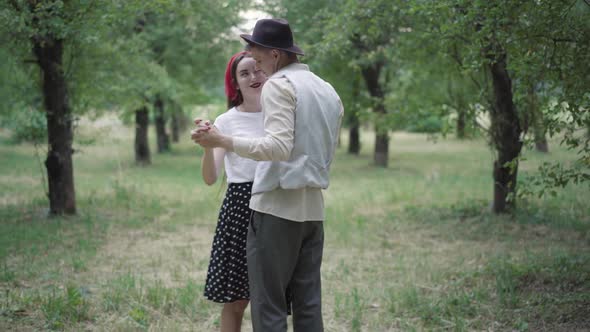 Slow Dance of Happy Elegant Young Couple in Summer Park, Smiling Loving Man and Woman Dancing alt